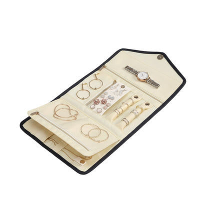 Interior compartments of jewelry storage bag holding rings and earrings